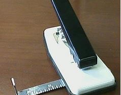 Stapler style slot punch with guide