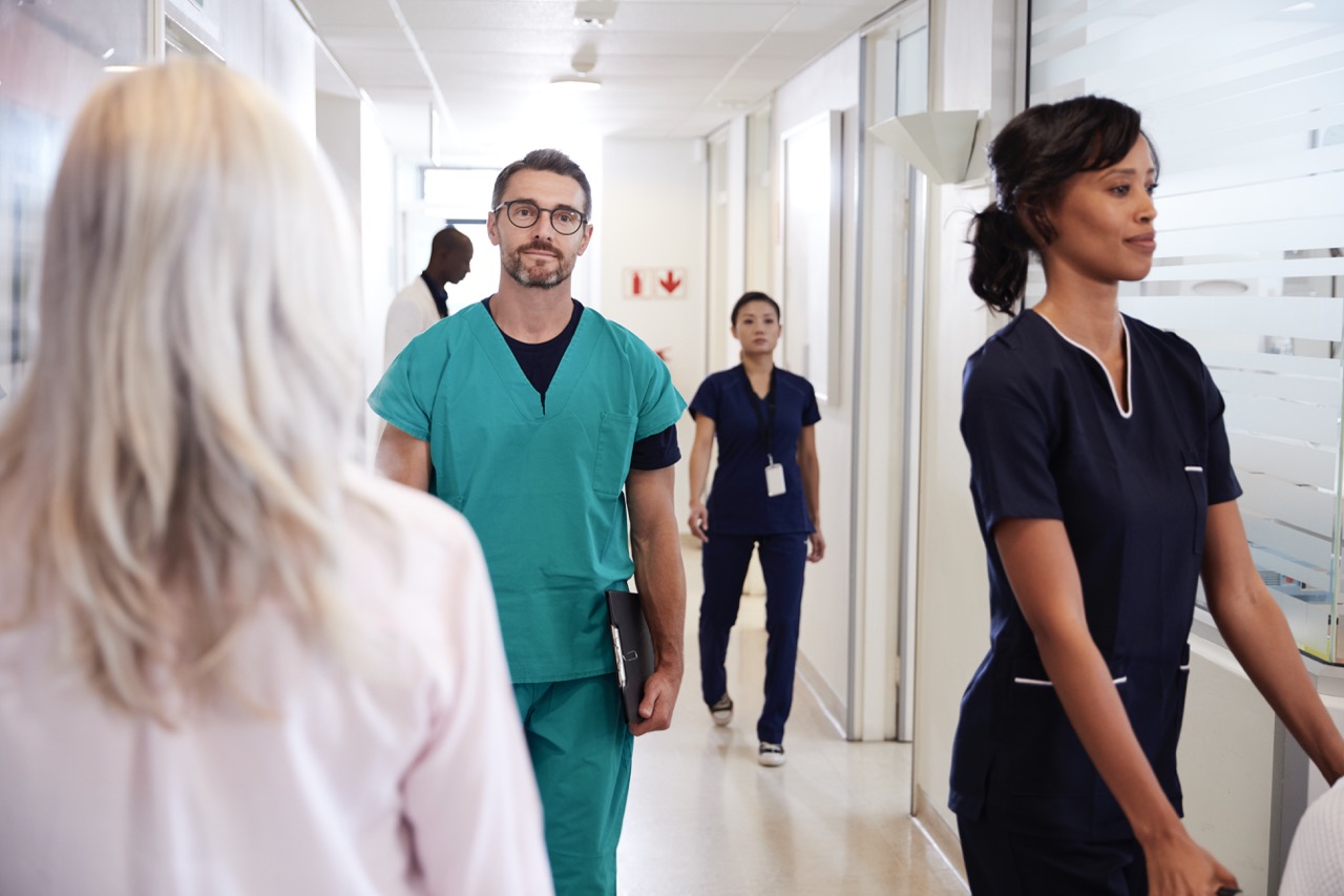 Busy hospital corridor with medical staff and secure access. 
